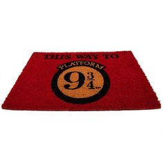 a red door mat with the number nine on it that says, this way to platform 9