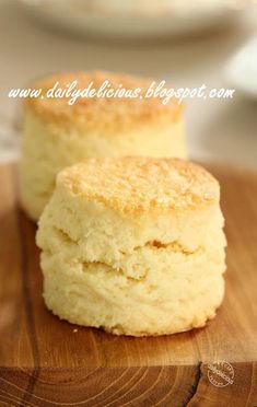 two biscuits sitting on top of a wooden cutting board