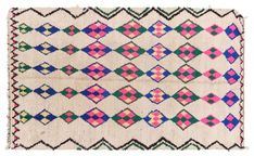 an old rug with colorful designs on the front and back side, in pink, green,