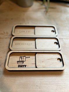 three wooden tags with the words dirty, breakfast, and dirty written in black on them