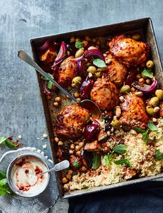 a pan filled with meat, beans and rice