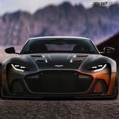 an orange and black sports car parked in the desert