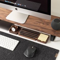 an apple computer sitting on top of a desk next to a keyboard and mouse pad