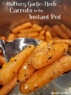 carrots in the instant pot are being held by a spoon