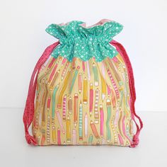 a drawstring bag with colorful toothbrushes on it