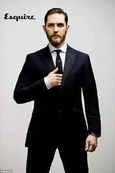 a man in a suit and tie posing for a picture