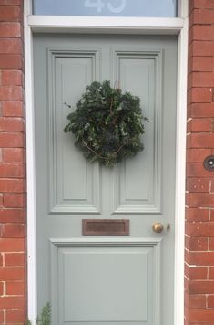 a green door with a wreath on it