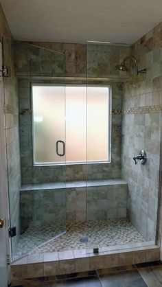 a walk in shower sitting next to a window with no curtains on it's sides