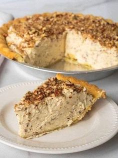 a piece of pie sitting on top of a white plate next to another pie dish