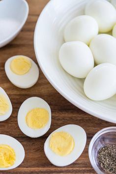 hard boiled eggs in a white bowl on a wooden table