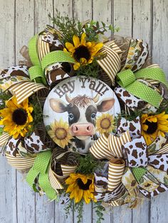 a wreath with sunflowers and a cow on it