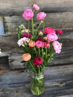 a vase filled with lots of different colored flowers