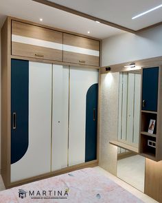 an empty bedroom with blue and white closets in the wall next to a bed