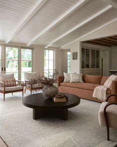 a living room filled with furniture and windows