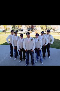 a group of men standing next to each other wearing white shirts and ties with hats on