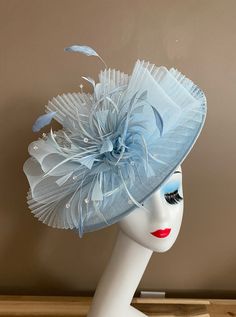 Elegant Light Blue Fascinator For Kentucky Derby, Elegant Blue Fascinator With Handmade Flowers, Adjustable Blue Fascinator With Feather Trim, Blue Feather Trim Headpiece For Wedding, Blue Feathered Mini Hat For Wedding, Blue Feathered Mini Hat For Weddings, Blue Mini Hats With Feathers For Wedding, Blue Wedding Headpiece With Feather Trim, Blue Hat With Feather Trim For Weddings