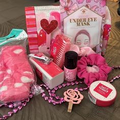 the contents of a valentine's day gift bag are laid out on a table