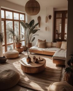 a living room filled with lots of furniture and plants