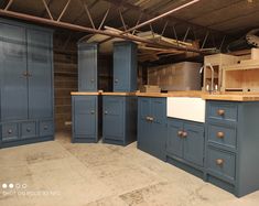 an unfinished kitchen with blue cabinets and counters