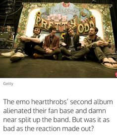 three men sitting on the ground in front of a sign that says, the emo heathtros'second album is also related to their fan base and damn near split up the band but was it as bad