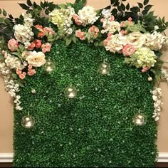 an artificial green wall with flowers and greenery