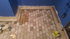 a bathroom floor that is being remodeled with wood planks and tile on the ground