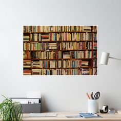 a bookshelf filled with lots of books sitting on top of a wooden desk