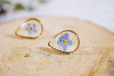 The beautiful and simple pressed flower earrings are perfect for either everyday wear or your special occasion. Both simple and elegant, these are made with carefully pressed forget me not  flowers, encased in our clear bio-resin so that they will last forever. You can choose silver or gold plated brass frames.*This pair is just a representation of the earrings you will receive. We work hard to ensure you get a beautiful product, but each pair will vary slightly in color and shape (but each is b Dainty Pressed Flower Earrings, Dainty Pressed Flower Earrings For Wedding, Elegant Teardrop Pressed Flower Earrings, Delicate Teardrop Flower Earrings For Anniversary, Forget Me Not, Flower Studs, Brass Frame, Flower Jewellery, Druzy Ring