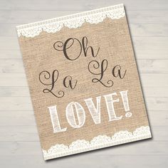 a sign that says oh la la love on burlocked paper with lace