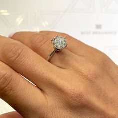 a woman's hand with a diamond ring on it