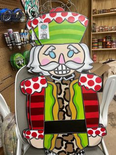 a chair with an image of a clown sitting on it's back in a store