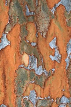 an orange and blue background with lots of rust on it's surface is shown