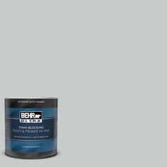 a can of behro ultra stain - blocking paint in dark blue, on a gray background