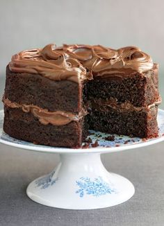 a chocolate cake on a plate with one slice cut out