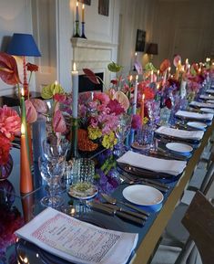 a long table is set with flowers and candles