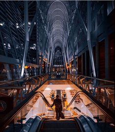 an escalator in a large building with people on it