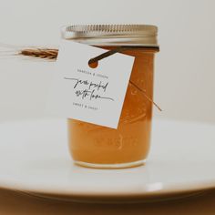 a jar filled with honey sitting on top of a white plate