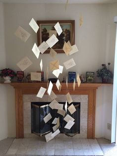 several pieces of paper are falling from the ceiling in front of a fire place with a fireplace