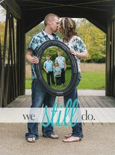 a man and woman kissing in front of a bridge with the words we are married