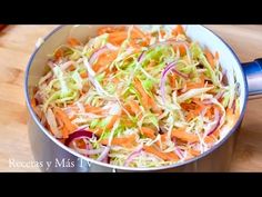 shredded carrots and cabbage in a pot on a cutting board