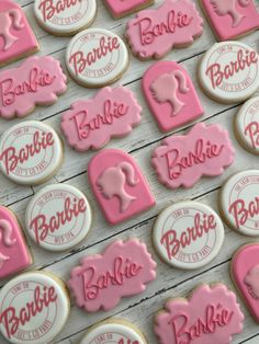 cookies decorated with pink and white icing sitting on top of a table