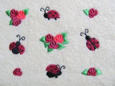 embroidered ladybugs and roses on a white towel