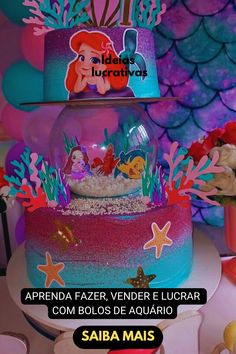 there is a cake with ariel the little mermaid on top and under it, surrounded by other decorations