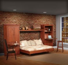 a bedroom with a bed, desk and bookshelf next to a brick wall