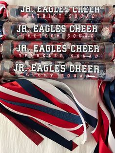 four red, white and blue ribbons are laying next to each other on a table