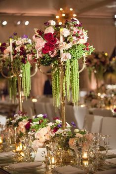 an elaborate table setting with flowers and candles