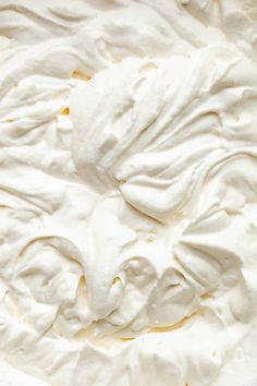 a close up of a cake with white frosting