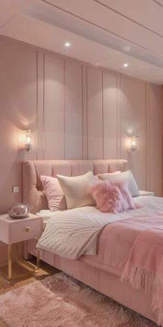 a bedroom with pink and white bedding and pillows on the headboard, along with two nightstands