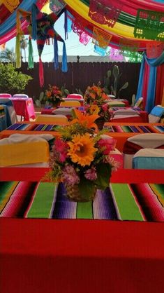 an image of a table set up for a party with flowers and decorations on it