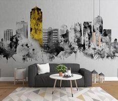 a living room with a couch, coffee table and large city skyline mural on the wall